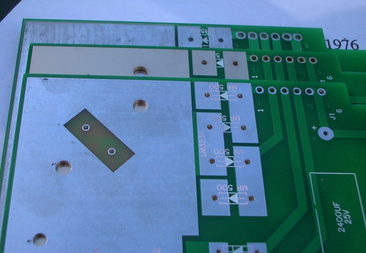 Closeup of the LM323 heat sink area. Note different PCB sizes.